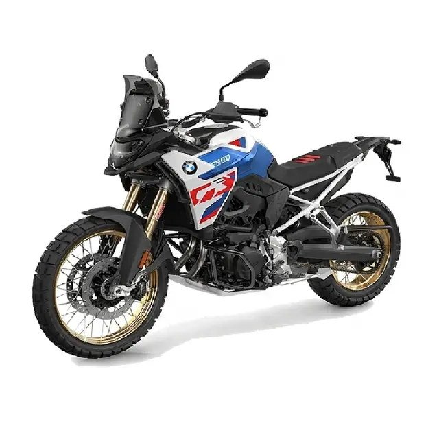 BMW F 900 GS in blue, white and red with gold spoked wheels, front three-quarter view